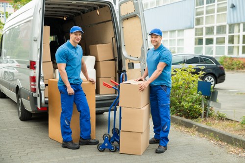 Removal team handling furniture and boxes in a Stockwell flat move