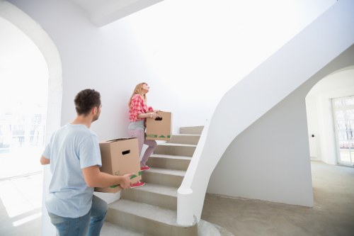 Removal workers carrying furniture from a Stockwell flat